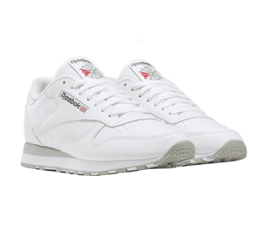 A pair of white Reebok Classic sneakers with gray outsoles.