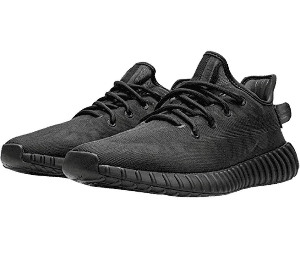 An all-black pair of Adidas YEEZY Boost 350 sneakers with vertically ribbed soles.