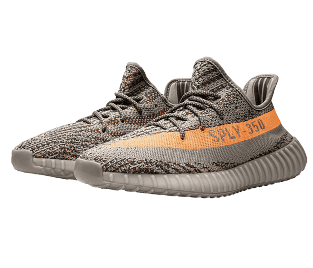 A sand brown, knitted pair of Adidas Yeezy sneakers with “SPLY-350” written backwards in an orange strip, on the lateral sides.