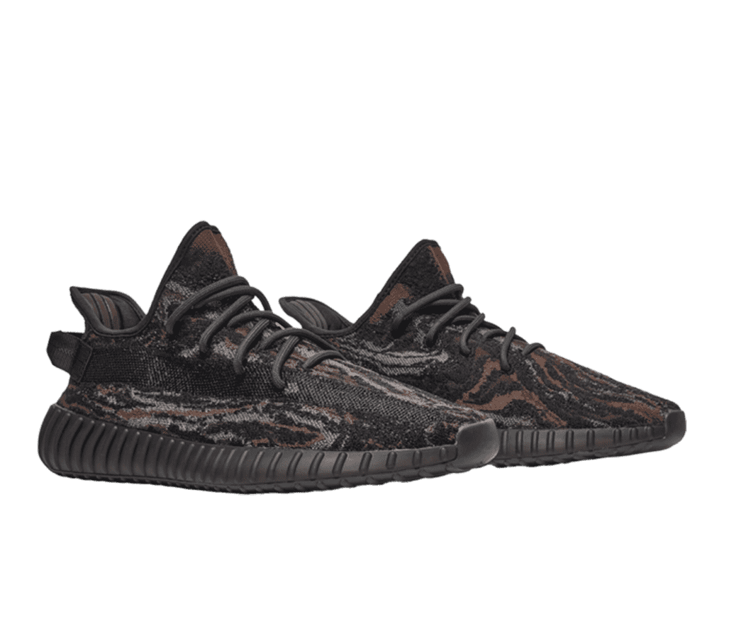 A pair of dark brown Yeezy sneakers. The shoe features a brown, gray, and tan camo pattern, with a brown stripe stretching across the middle of the sides. The laces and soles are the same shade of dark brown.